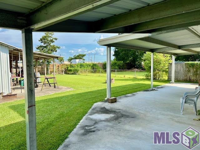119 Lydia Street Patterson, LA 70392 - Photo 16 of 25 backyard carport