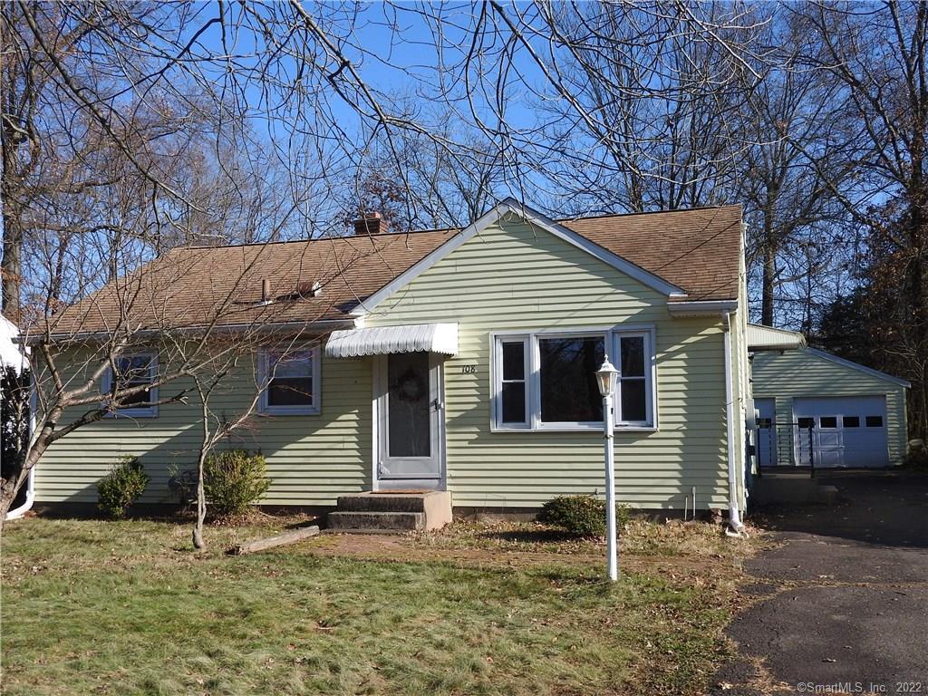 a view of a house with a yard and wooden fence