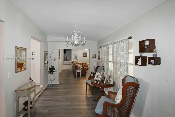a view of a livingroom with furniture and a chandelier