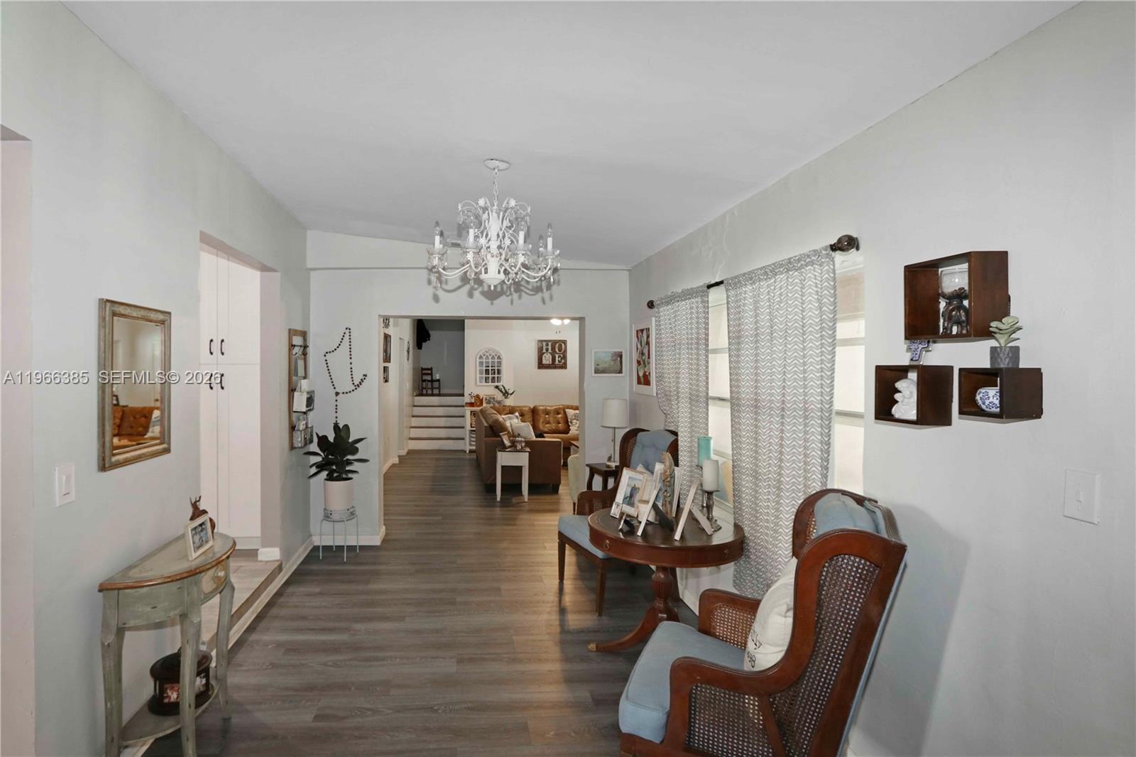 1221 Southwest 74th Court Miami, FL 33144 - Photo 11 of 42 a view of a livingroom with furniture and a chandelier