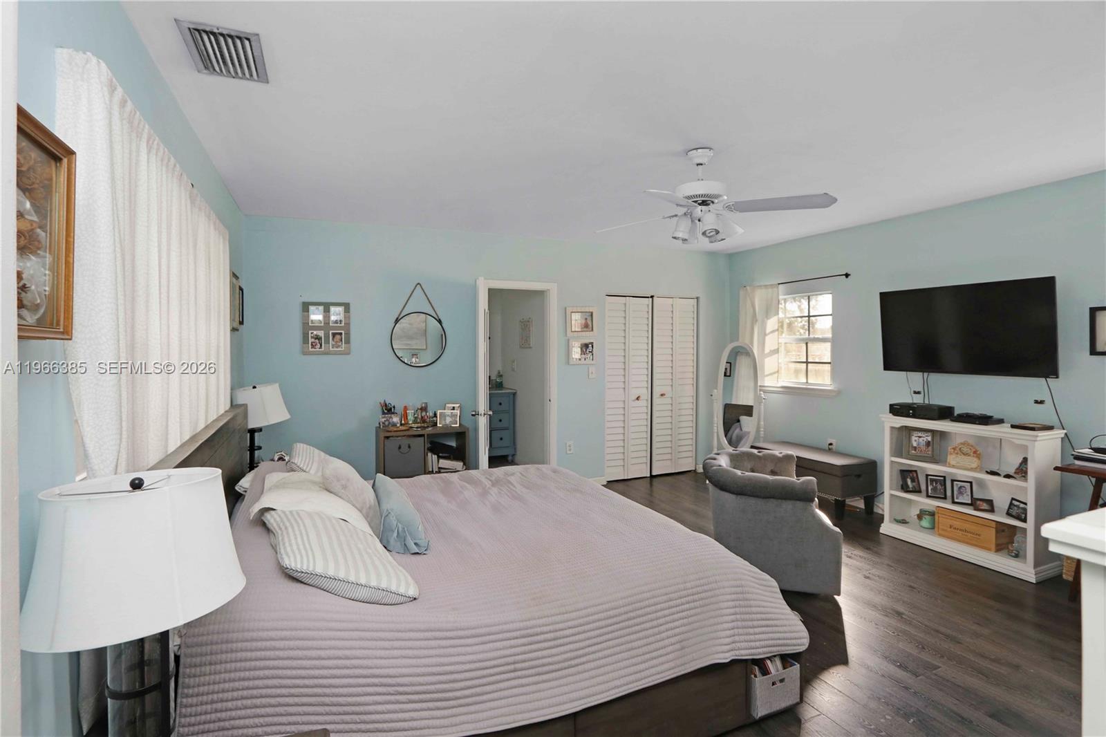 1221 Southwest 74th Court Miami, FL 33144 - Photo 13 of 42 a bedroom with a bed and a flat screen tv