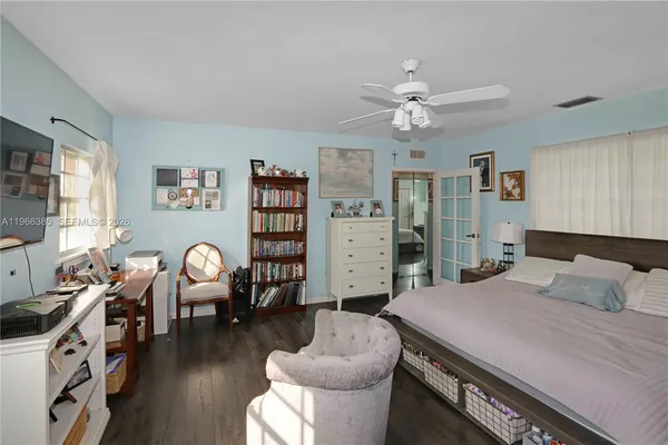 a bedroom with furniture and a large window