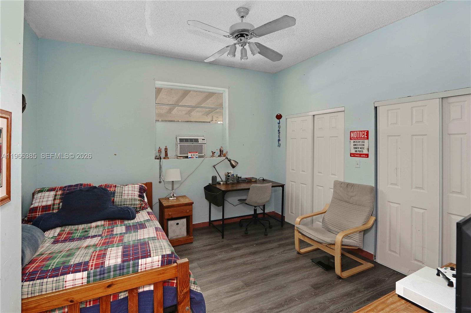 1221 Southwest 74th Court Miami, FL 33144 - Photo 18 of 42 a bedroom with furniture and wooden floor