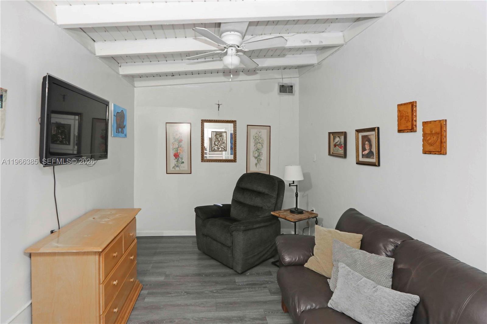 1221 Southwest 74th Court Miami, FL 33144 - Photo 19 of 42 a living room with furniture and a flat screen tv