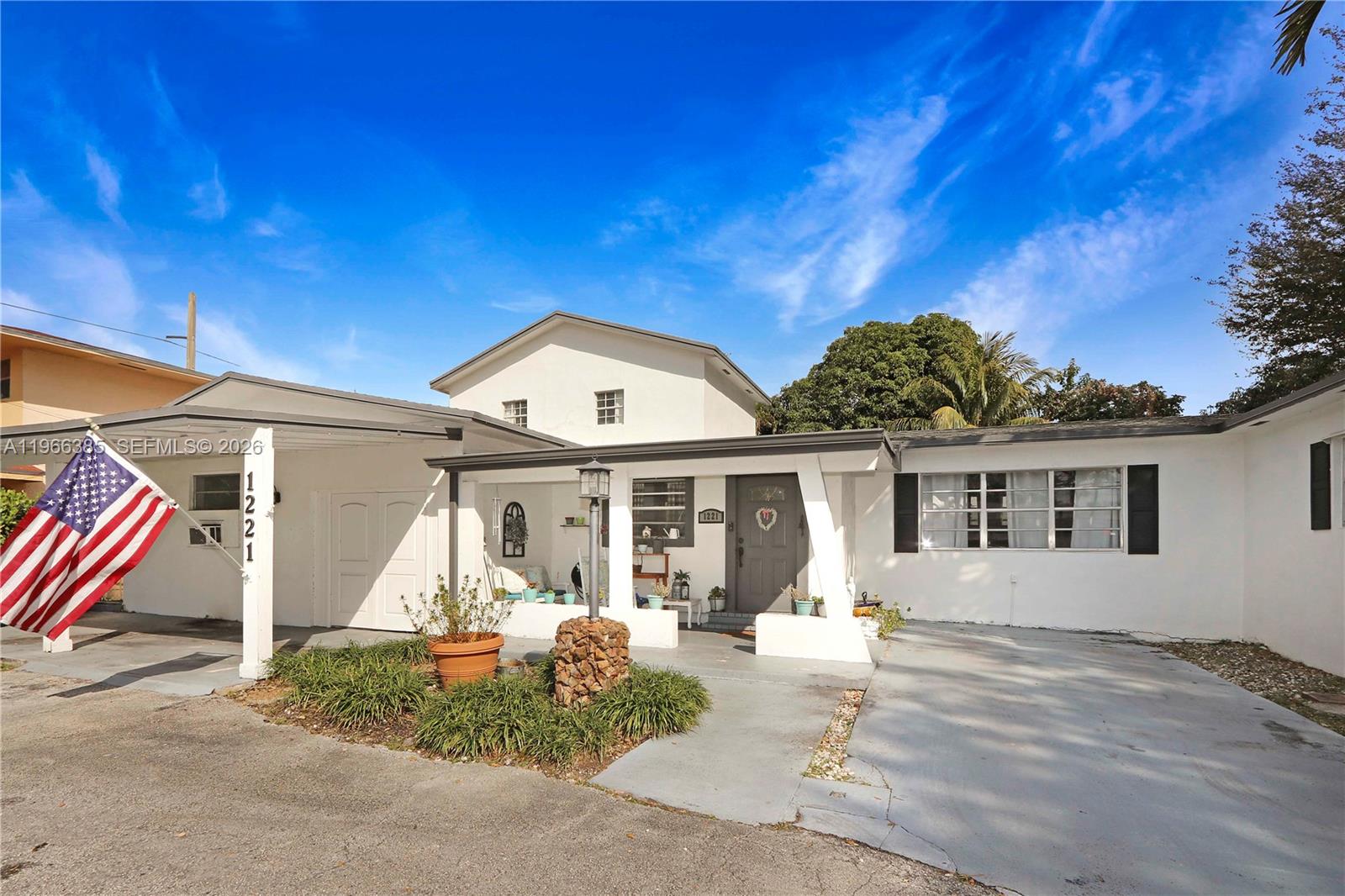1221 Southwest 74th Court Miami, FL 33144 - Photo 2 of 42 a front view of a house with a yard