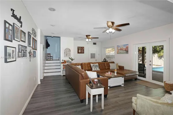 a living room with furniture and a wooden floor