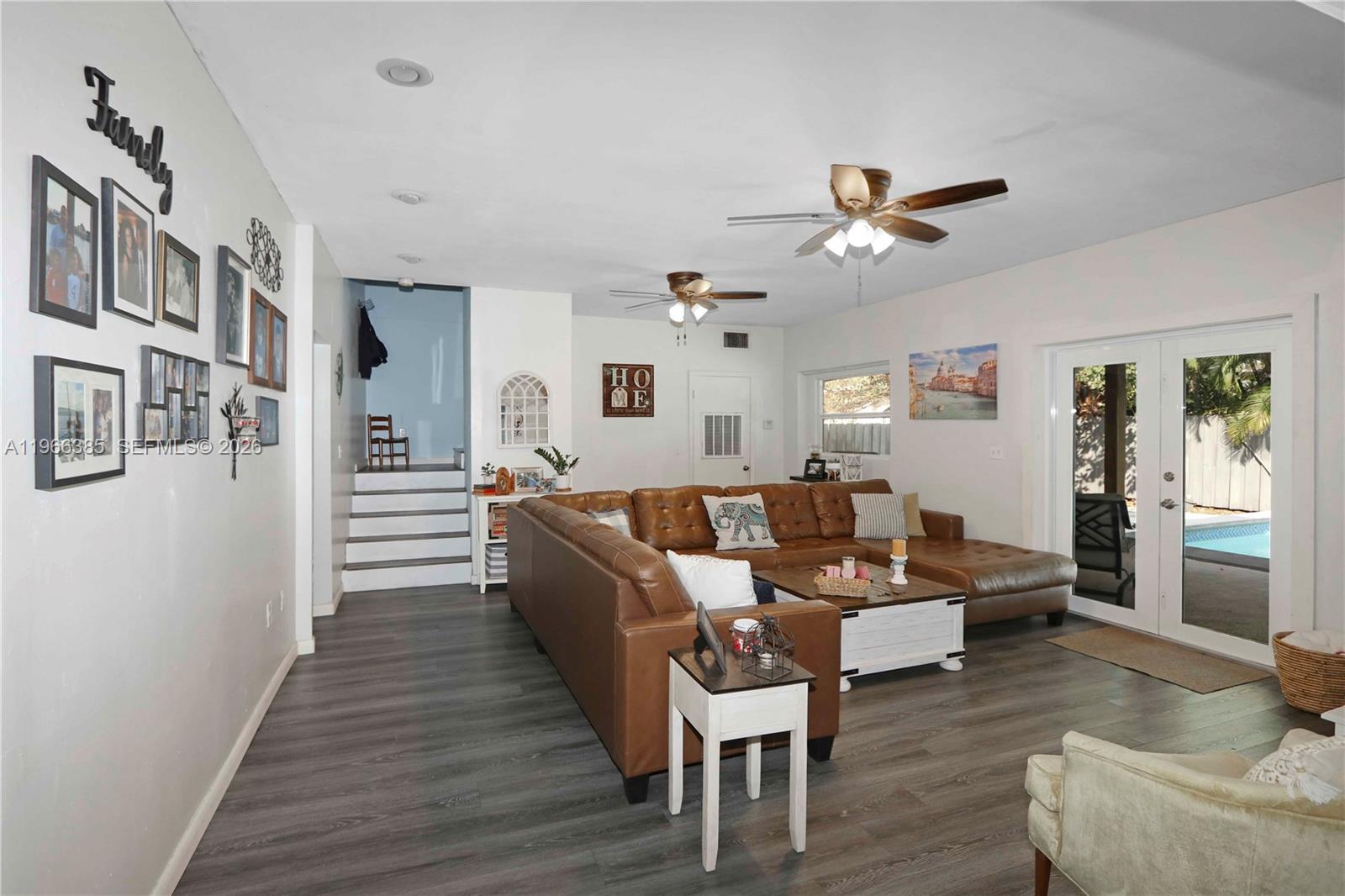 1221 Southwest 74th Court Miami, FL 33144 - Photo 3 of 42 a living room with furniture and a wooden floor