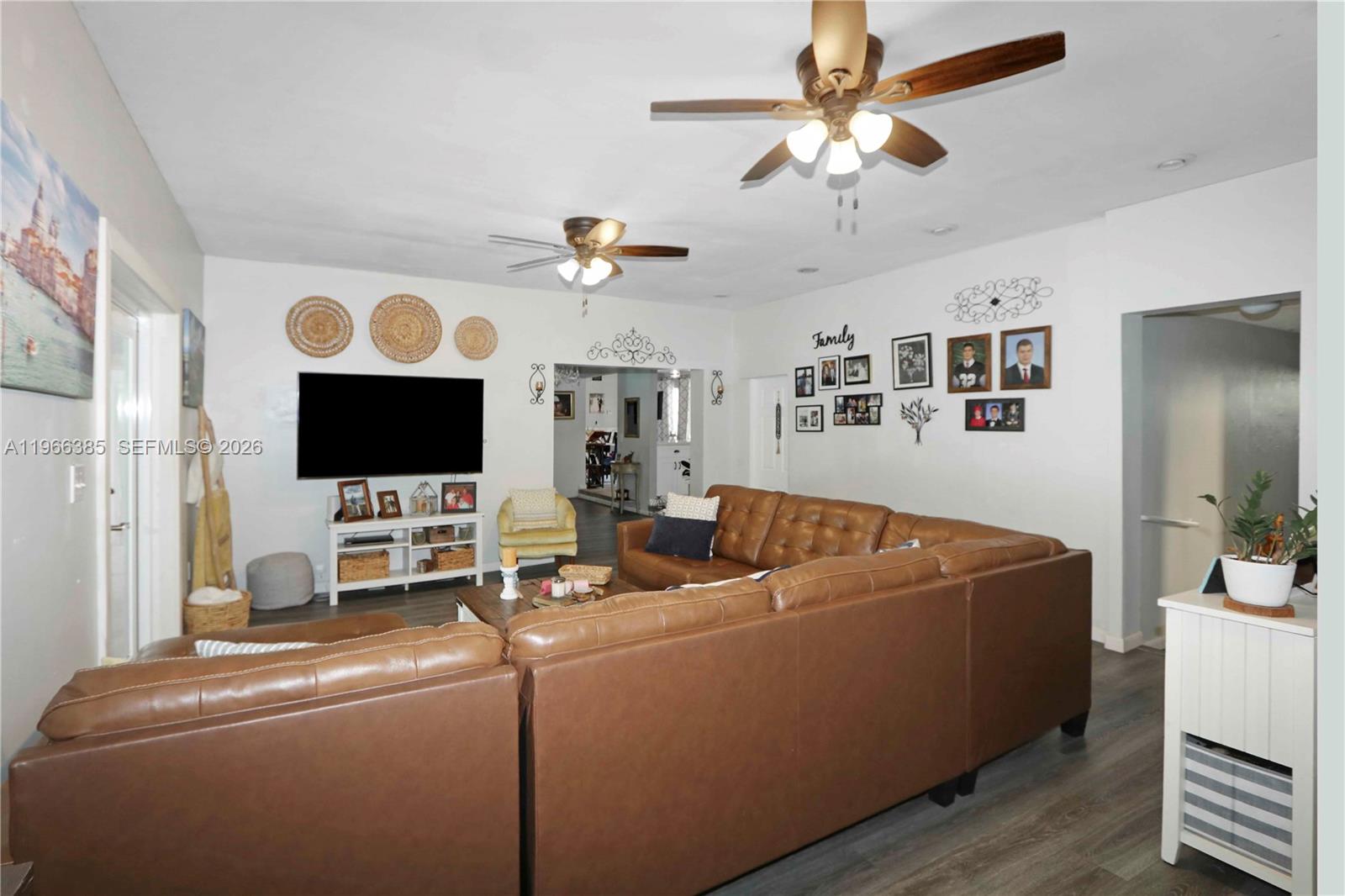 1221 Southwest 74th Court Miami, FL 33144 - Photo 4 of 42 a living room with furniture and a flat screen tv