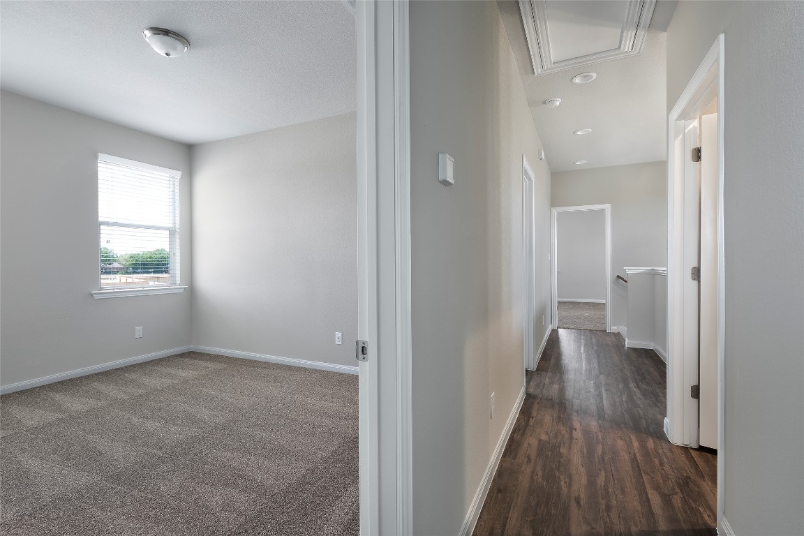 404 San Gabriel River Road Georgetown, TX 78626 - Photo 6 of 6 an empty room with wooden floor and windows