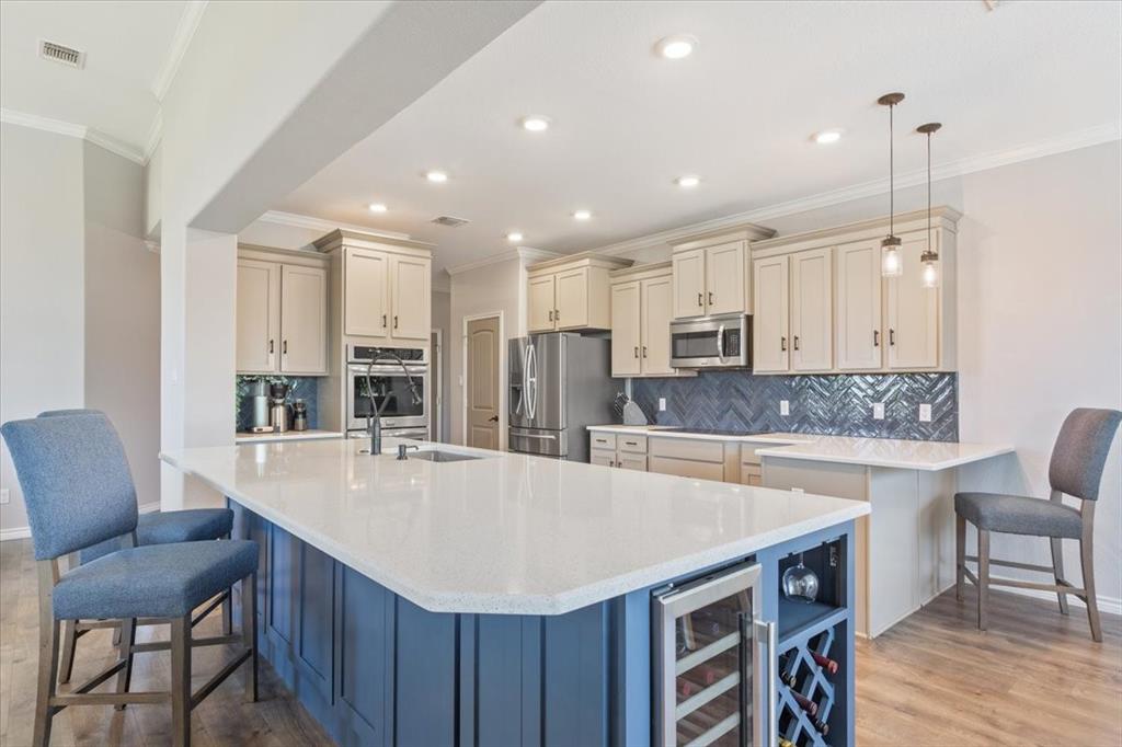101 Rancho Lorena Drive Lorena, TX 76655 - Photo 16 of 40 a large kitchen with kitchen island a dining table and chairs