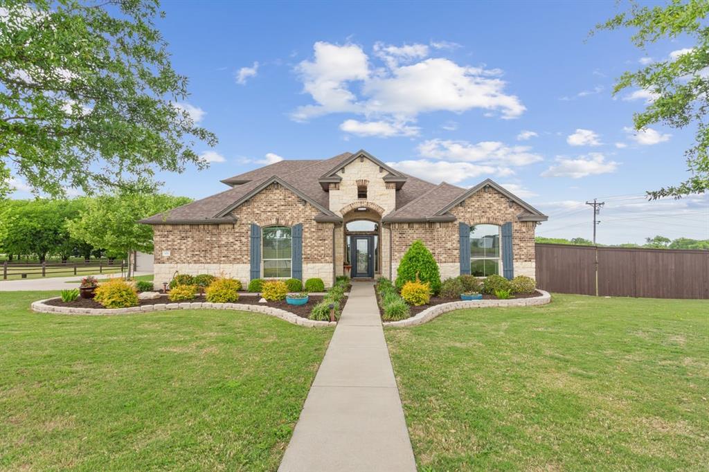 101 Rancho Lorena Drive Lorena, TX 76655 - Photo 3 of 40 a front view of a house with a yard and potted plants
