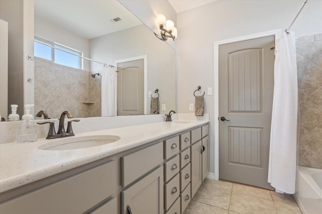 101 Rancho Lorena Drive Lorena, TX 76655 - Photo 9 of 40 a bathroom with a double vanity sink and a mirror