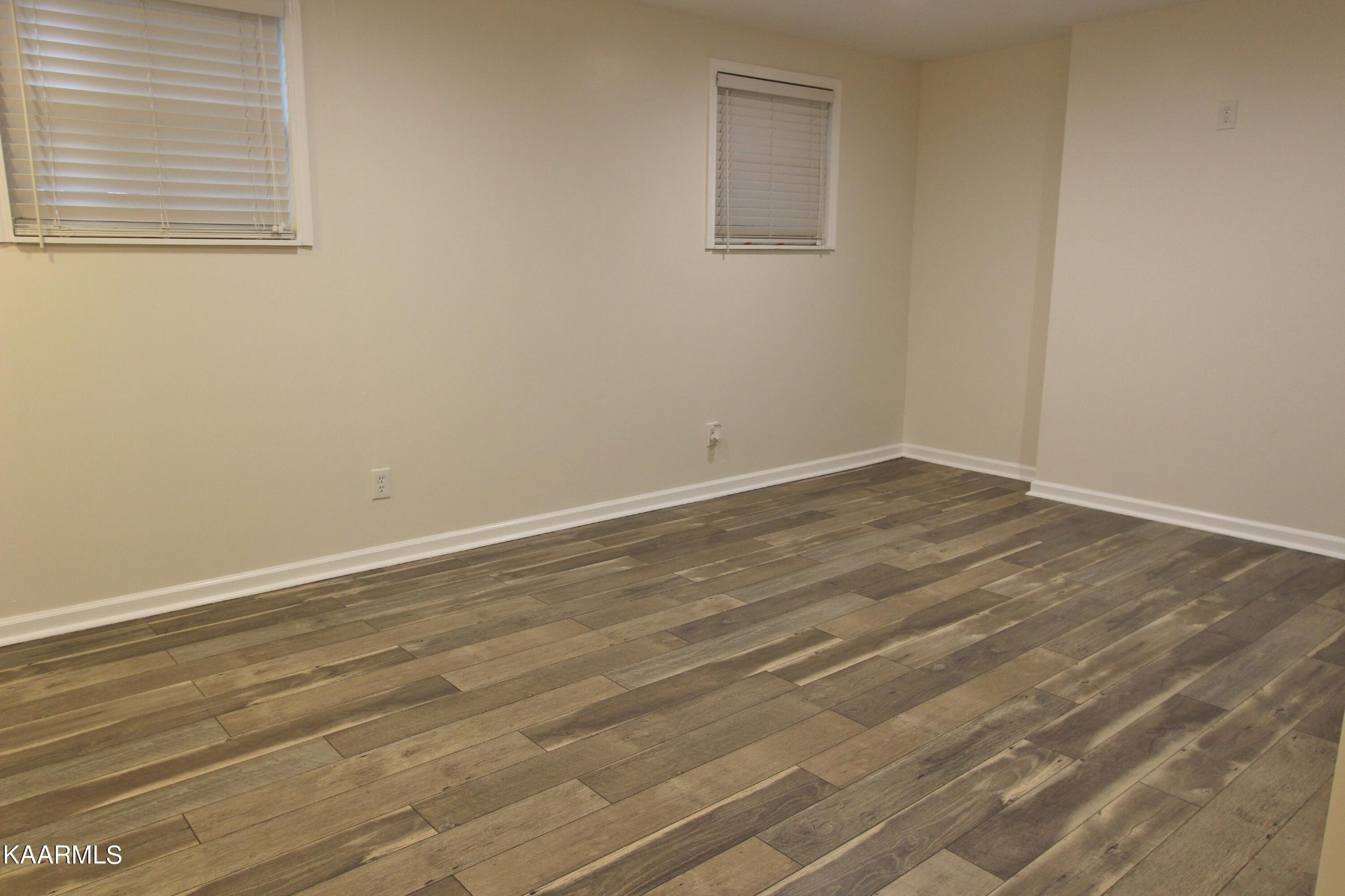 4222 Abercorn Road Knoxville, TN 37921 - Photo 17 of 33 a view of an empty room with wooden floor and a window