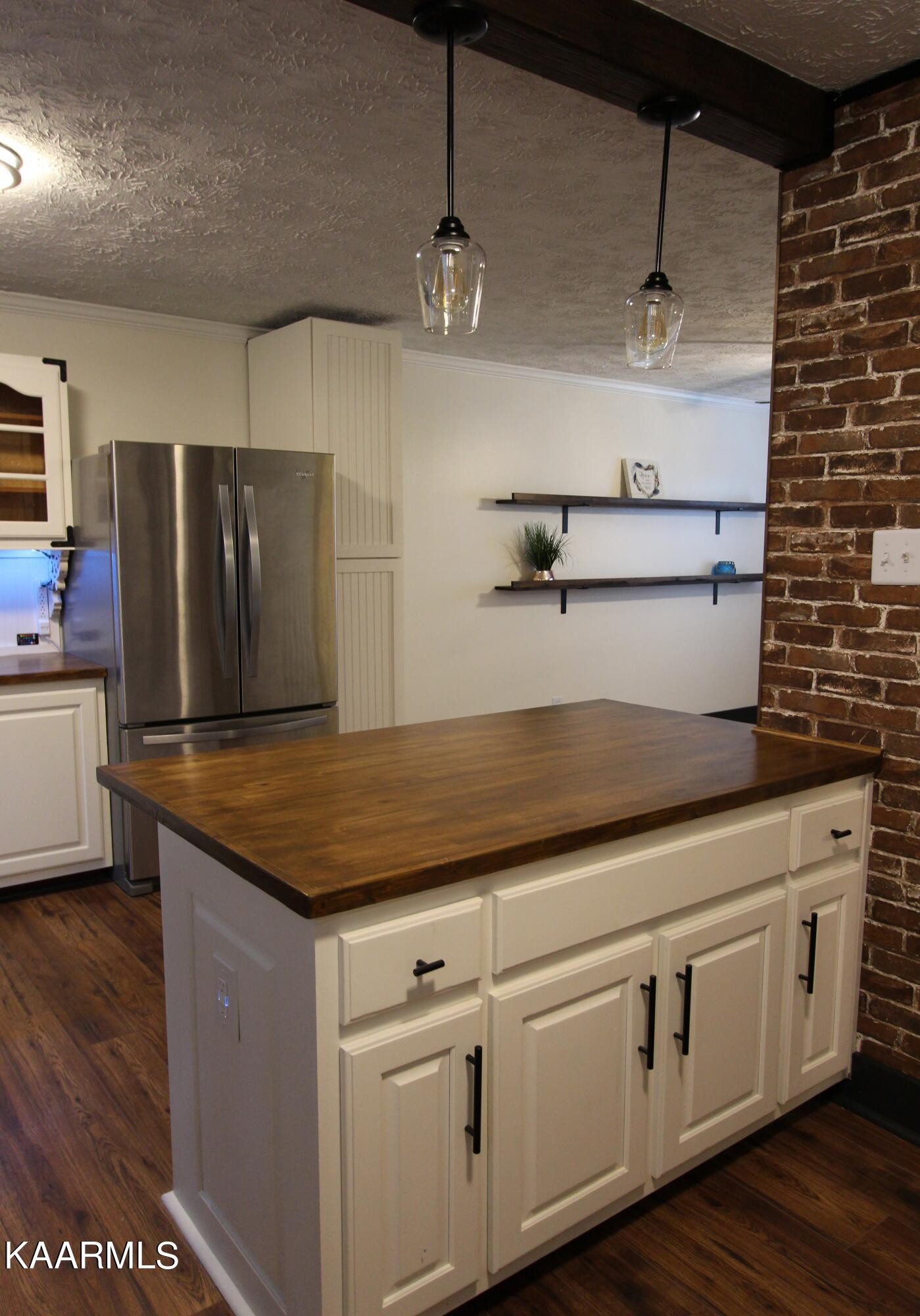 4222 Abercorn Road Knoxville, TN 37921 - Photo 10 of 33 a kitchen with cabinets wooden floor and stainless steel appliances