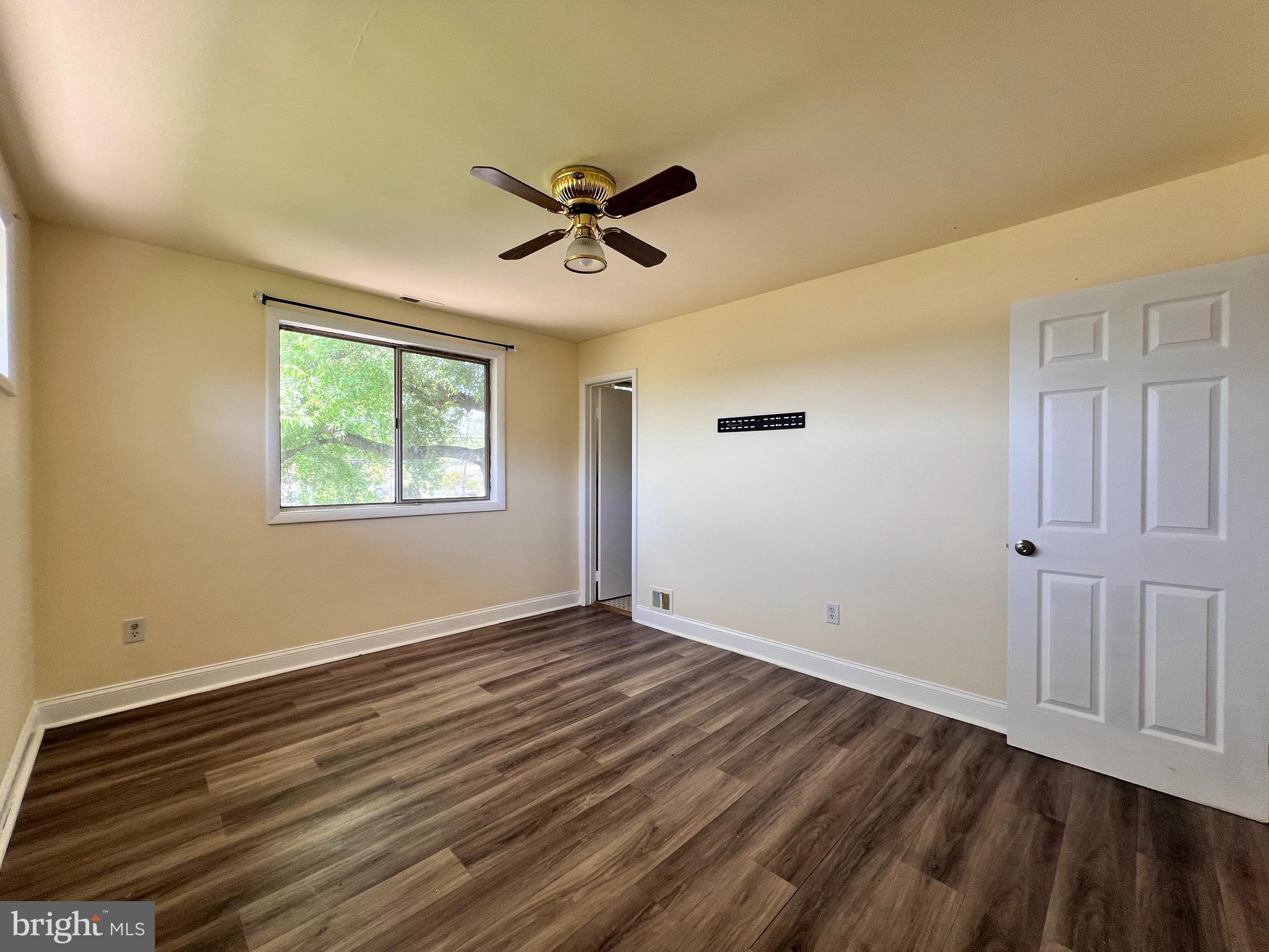9227 Riggs Road Adelphi, MD 20783 - Photo 21 of 78 a view of empty room with wooden floor and fan