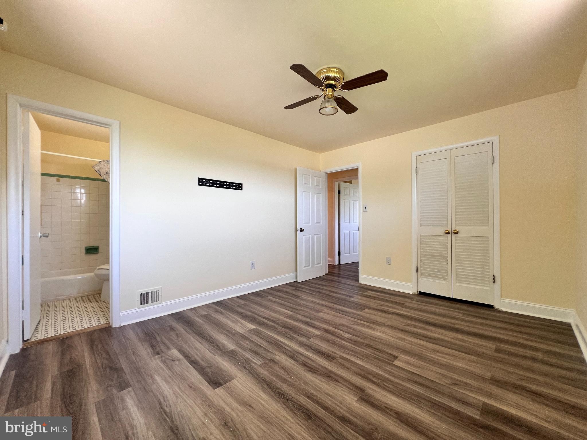 9227 Riggs Road Adelphi, MD 20783 - Photo 22 of 78 a view of empty room with wooden floor and window