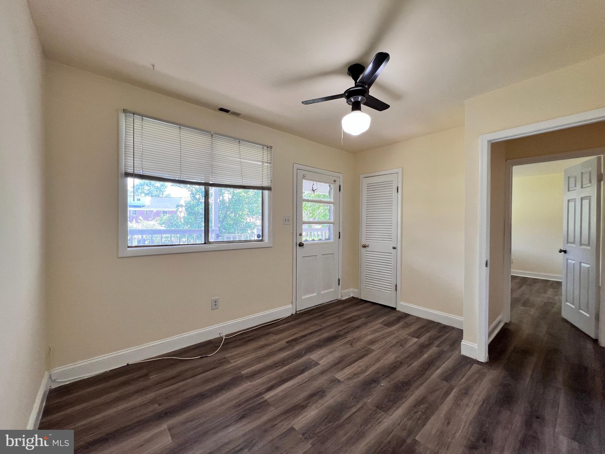 9227 Riggs Road Adelphi, MD 20783 - Photo 26 of 78 a view of an empty room with wooden floor and a window