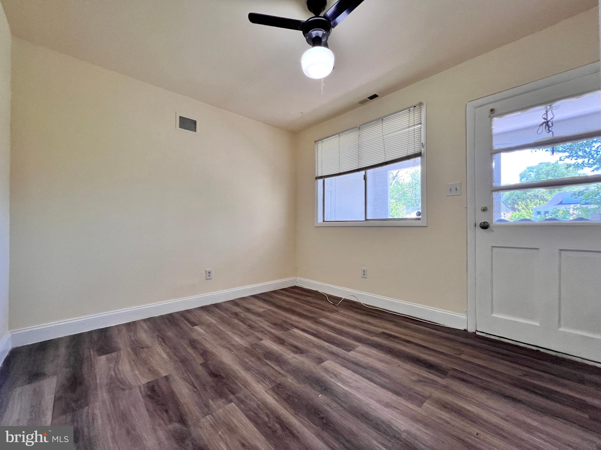 9227 Riggs Road Adelphi, MD 20783 - Photo 28 of 78 wooden floor in an empty room with a window