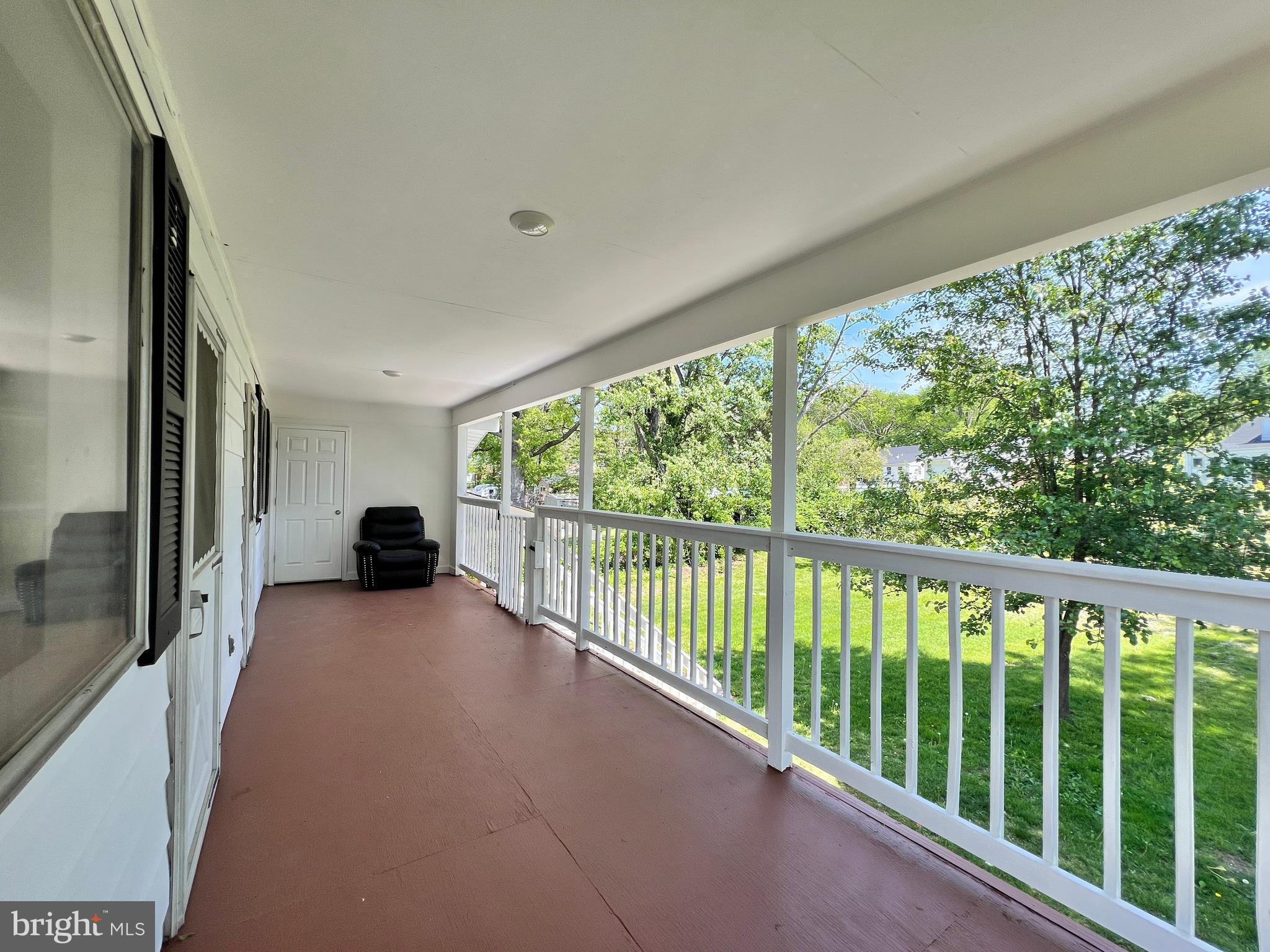 9227 Riggs Road Adelphi, MD 20783 - Photo 31 of 78 a view of a porch with wooden floor and outdoor space