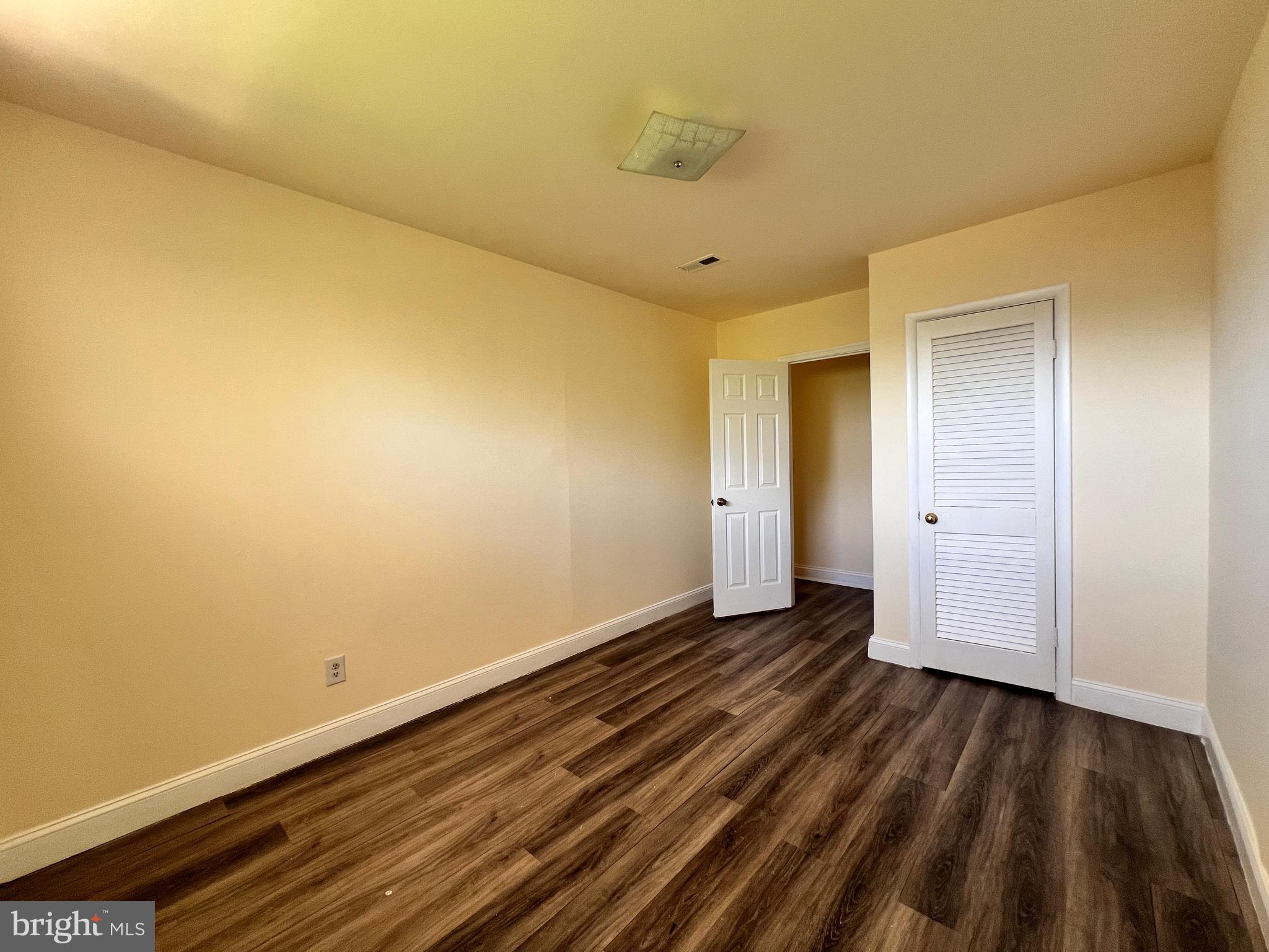 9227 Riggs Road Adelphi, MD 20783 - Photo 33 of 78 a view of an empty room and wooden floor
