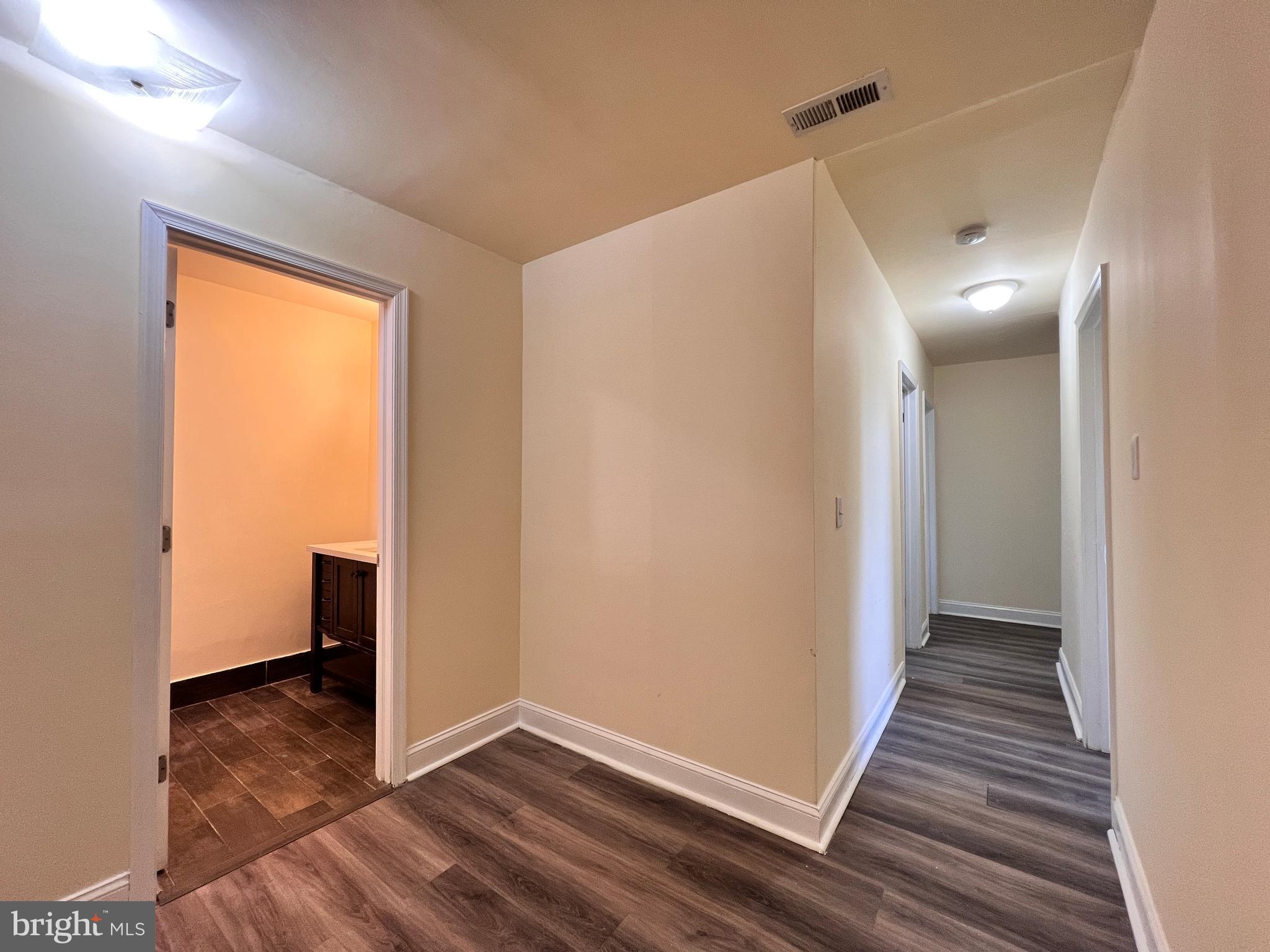9227 Riggs Road Adelphi, MD 20783 - Photo 37 of 78 a view of an empty room with wooden floor and a window