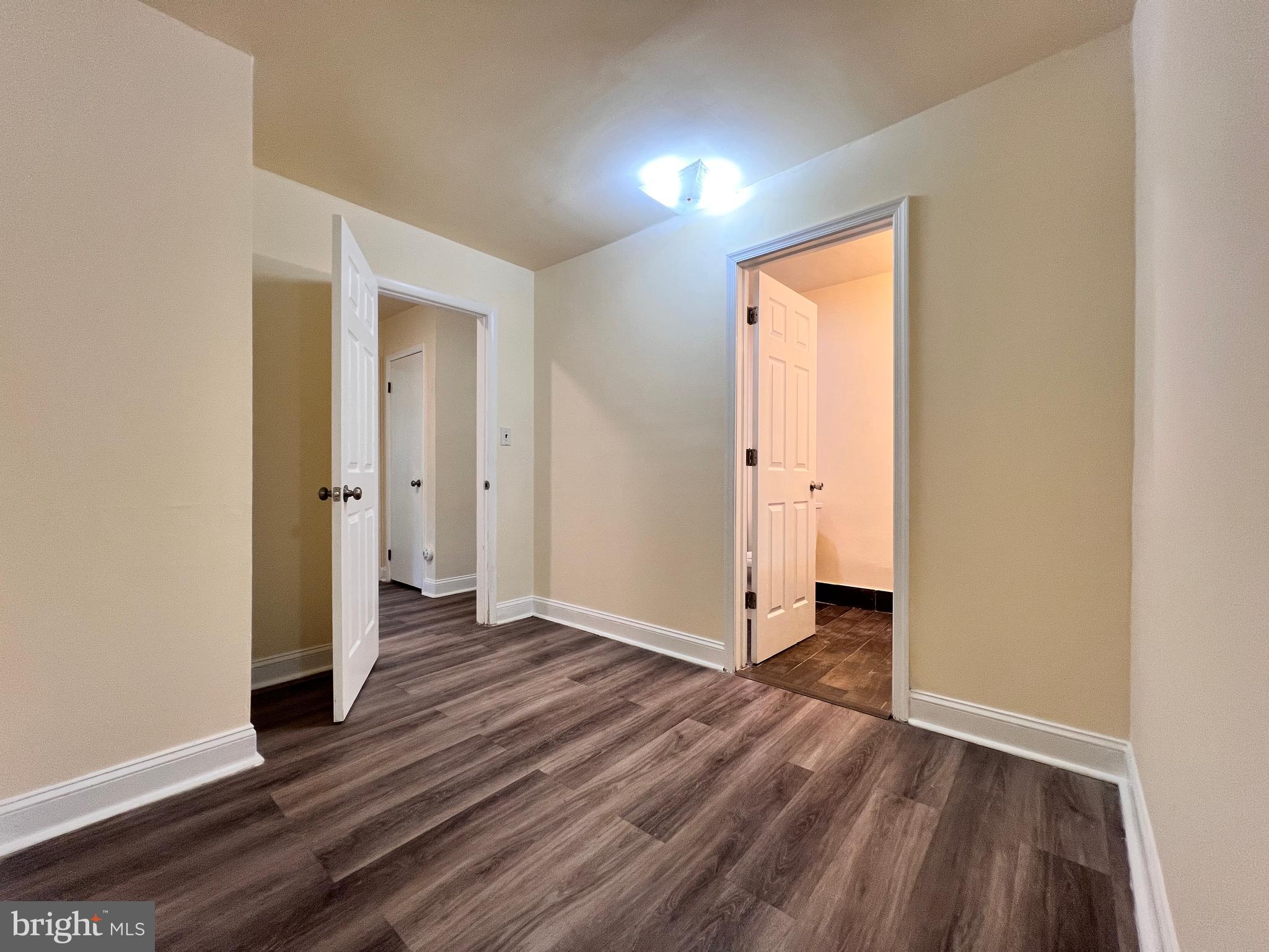 9227 Riggs Road Adelphi, MD 20783 - Photo 38 of 78 an empty room with wooden floor and entrance