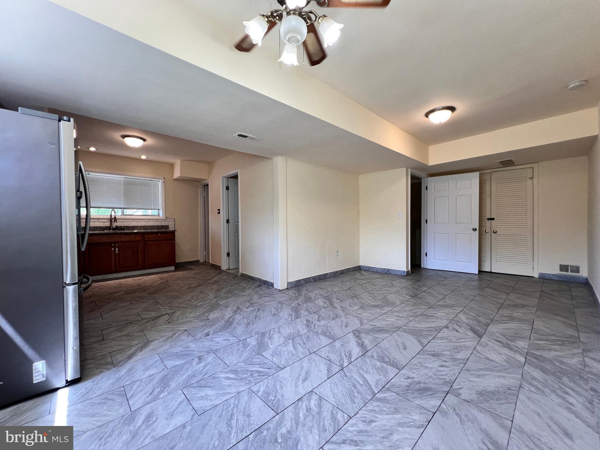9227 Riggs Road Adelphi, MD 20783 - Photo 39 of 78 a view of a kitchen with a sink and a stove top oven