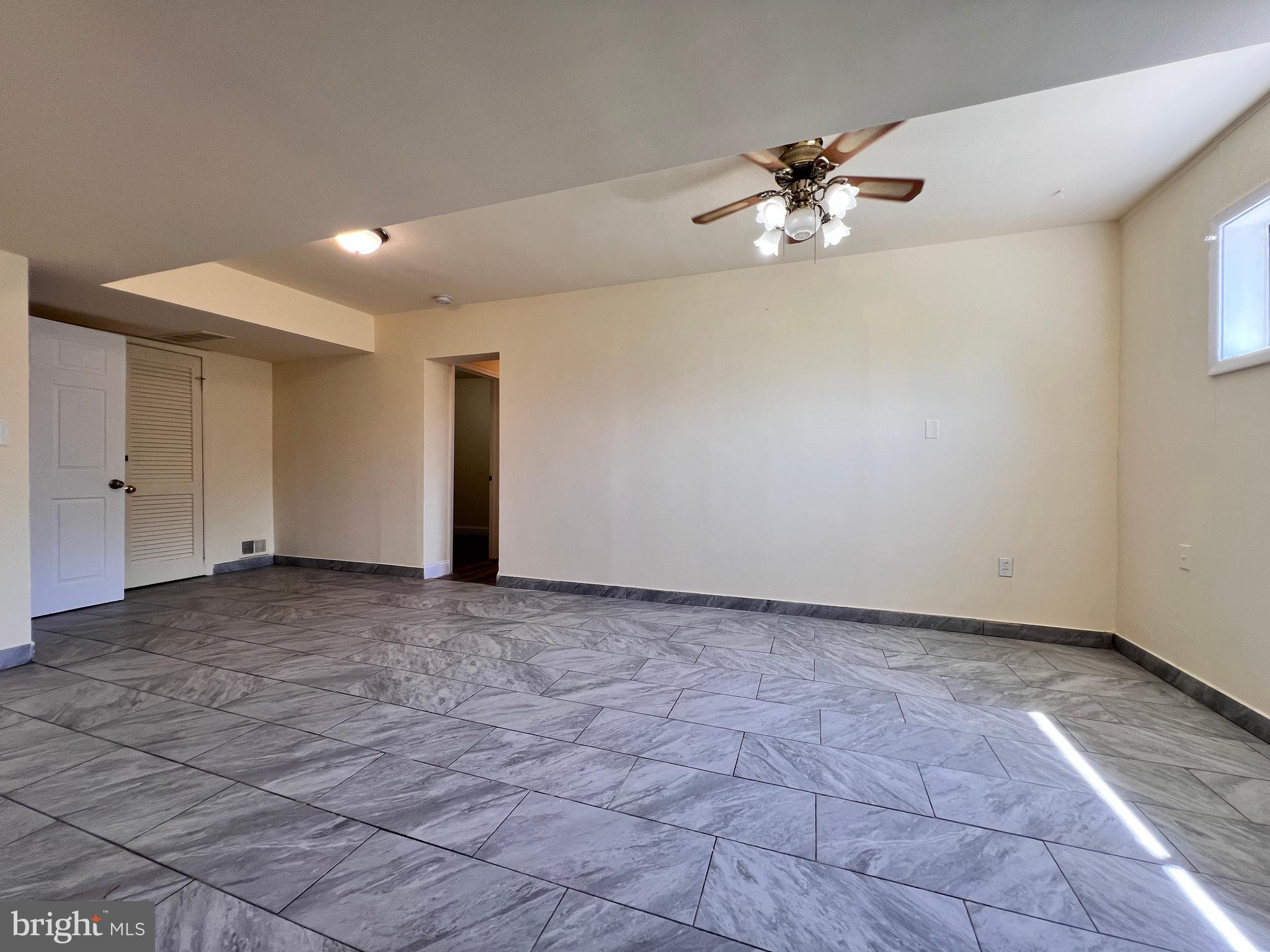 9227 Riggs Road Adelphi, MD 20783 - Photo 42 of 78 a view of a livingroom with a ceiling fan and window