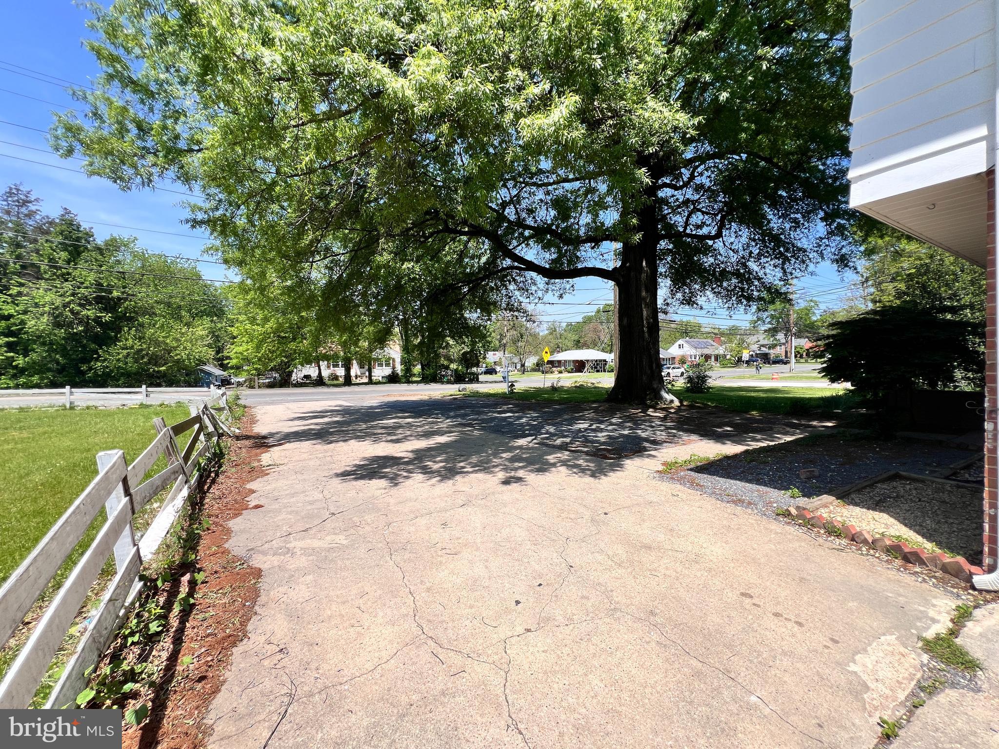9227 Riggs Road Adelphi, MD 20783 - Photo 7 of 78 a view of a street with trees on both side of it