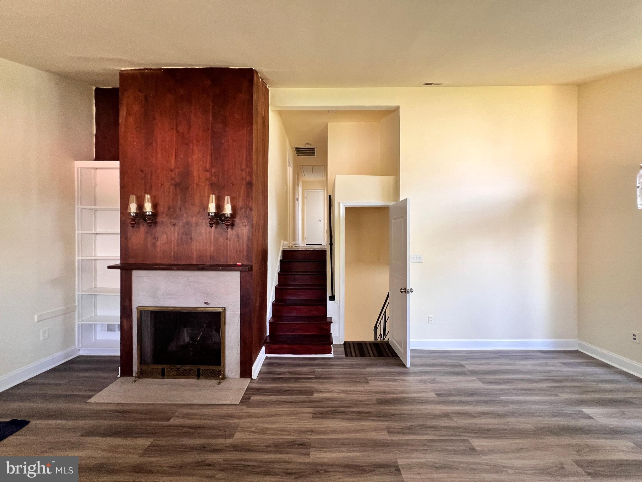 9227 Riggs Road Adelphi, MD 20783 - Photo 9 of 78 a view of a livingroom with wooden floor and a fireplace