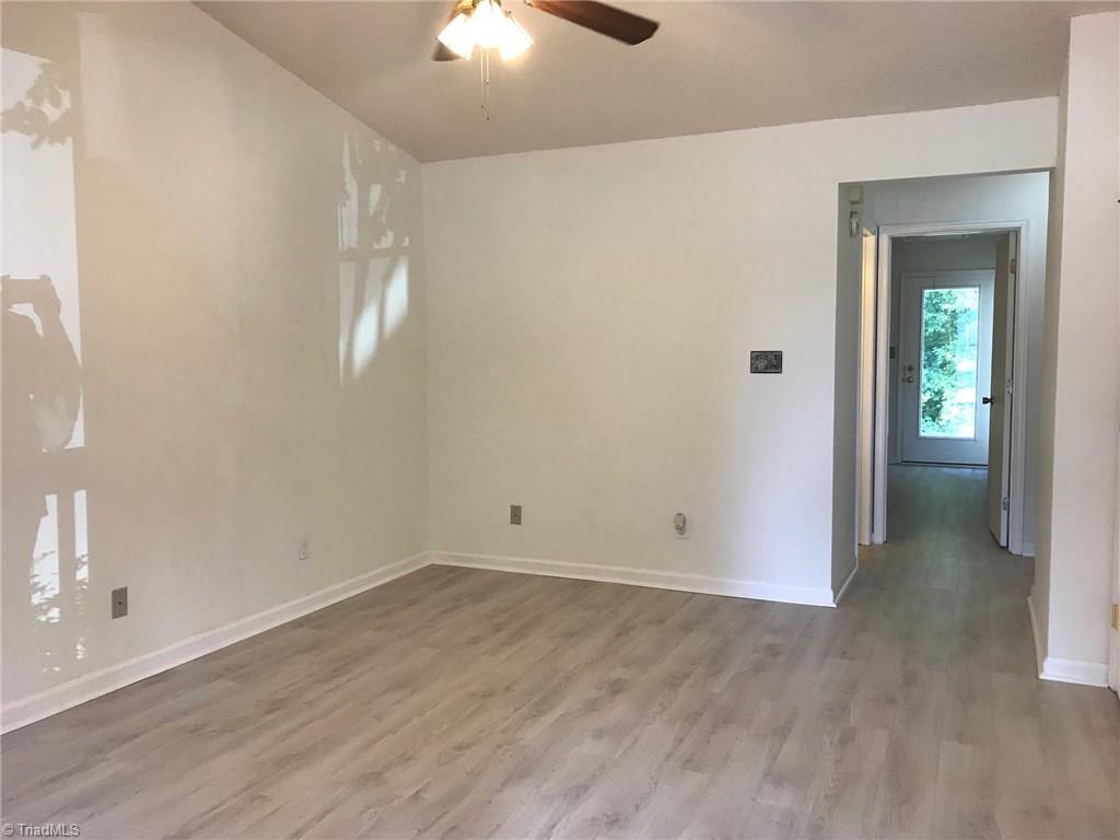 3128 Windchase Court High Point, NC 27265 - Photo 7 of 11 Bright and airy Living Room with new laminate floors and paint.