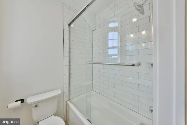 a bathroom with a shower and toilet