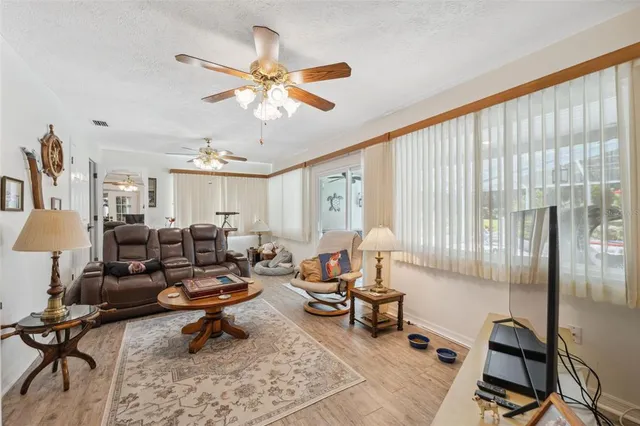 a spacious bedroom with a bed a couch and dresser