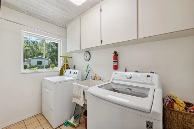 a view of a house with a big yard and potted plants