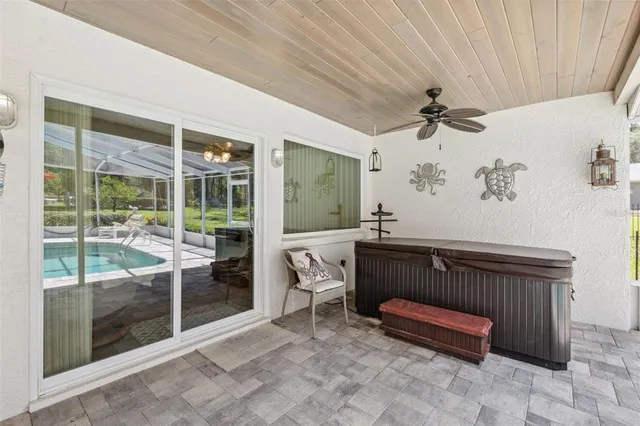 a view of a swimming pool with a table and chairs under an umbrella