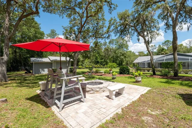 an aerial view of a house with a yard and lake view