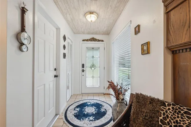 a living room with furniture a fireplace and a large window
