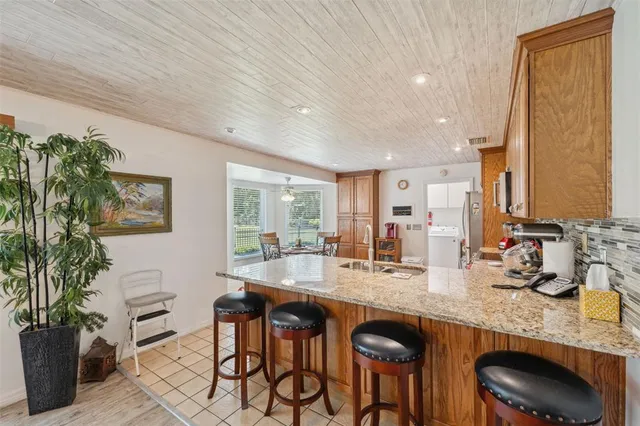 a kitchen with stainless steel appliances granite countertop a refrigerator sink and stove