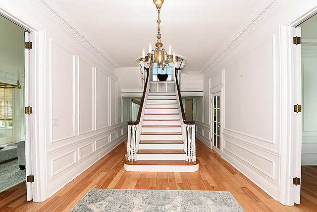 596 Arbor Vitae Road Winnetka, IL 60093 - Photo 30 of 62 a view of a hallway with wooden floor and staircase