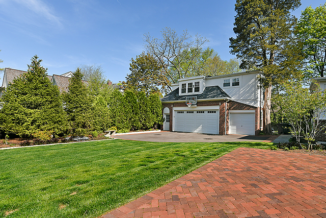 596 Arbor Vitae Road Winnetka, IL 60093 - Photo 52 of 62 a front view of a house with a yard and garage
