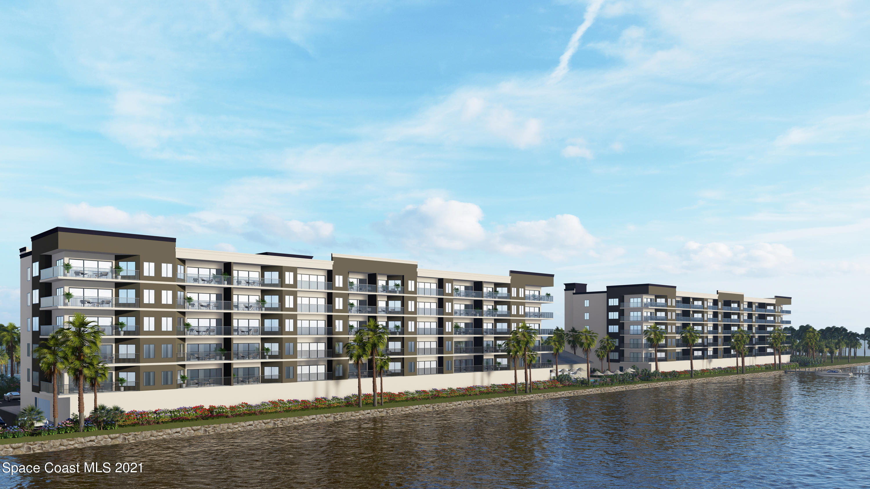 1805 Riverside Drive, Unit 306N Titusville, FL 32780 - Photo 6 of 8 a view of a large building with a lake