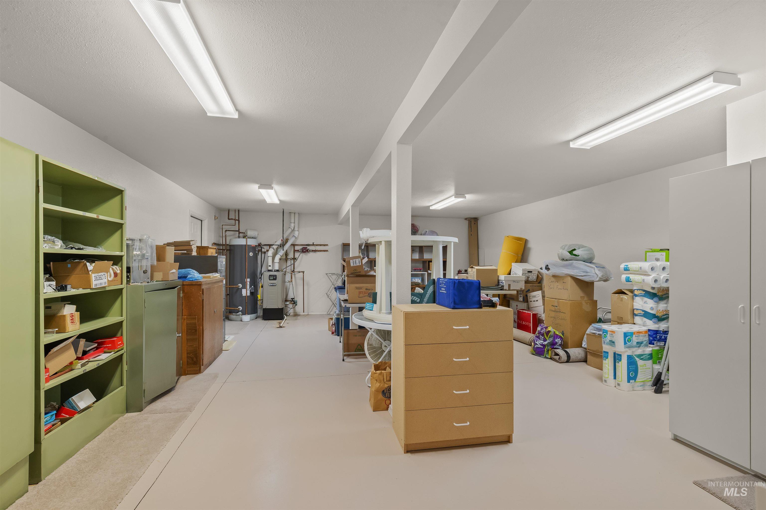 743 Wall Crk Road Stites, ID 83552 - Photo 37 of 48 Spacious utility area featuring multiple exposed support beams, overhead fluorescent lighting, and light-toned flooring