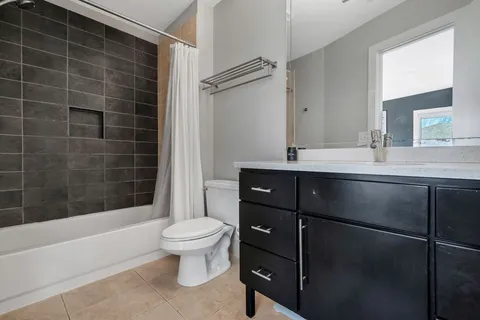 a bathroom with a sink toilet vanity and shower