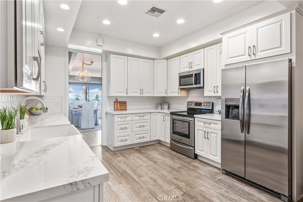 30175 Ave Tranquila Rancho Palos Verdes, CA 90275 - Photo 11 of 35 a kitchen with granite countertop a refrigerator stove top oven and sink