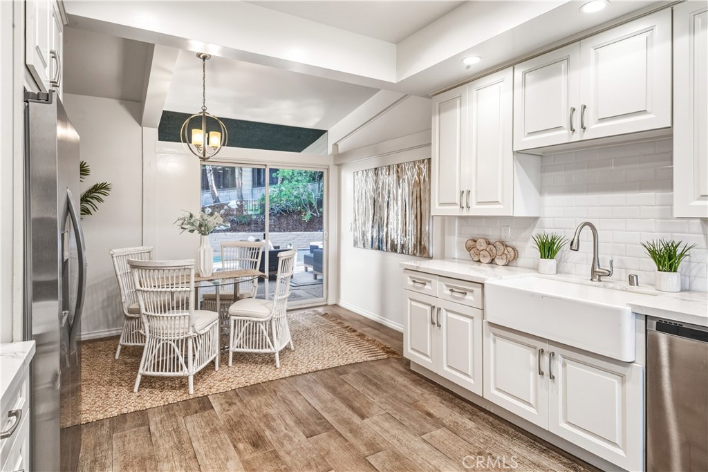 30175 Ave Tranquila Rancho Palos Verdes, CA 90275 - Photo 12 of 35 a large kitchen with white cabinets and wooden floor