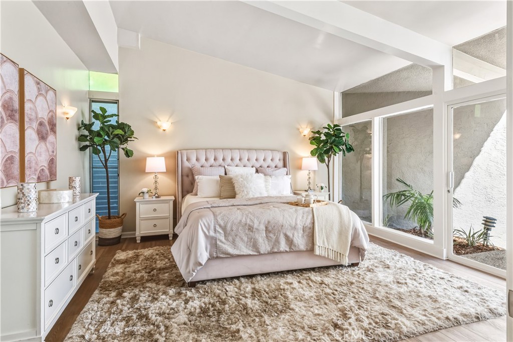30175 Ave Tranquila Rancho Palos Verdes, CA 90275 - Photo 13 of 35 a spacious bedroom with a large bed and a potted plant