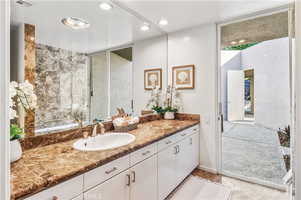 30175 Ave Tranquila Rancho Palos Verdes, CA 90275 - Photo 15 of 35 a bathroom with a granite countertop sink and a mirror