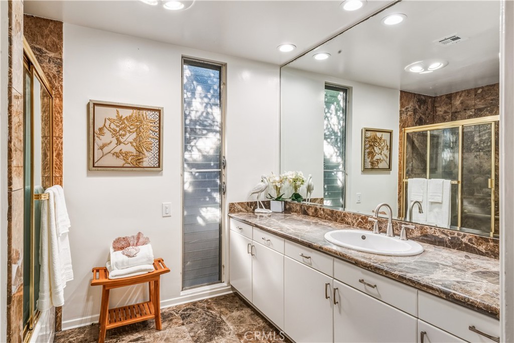 30175 Ave Tranquila Rancho Palos Verdes, CA 90275 - Photo 22 of 35 a spacious bathroom with a granite countertop sink and a mirror