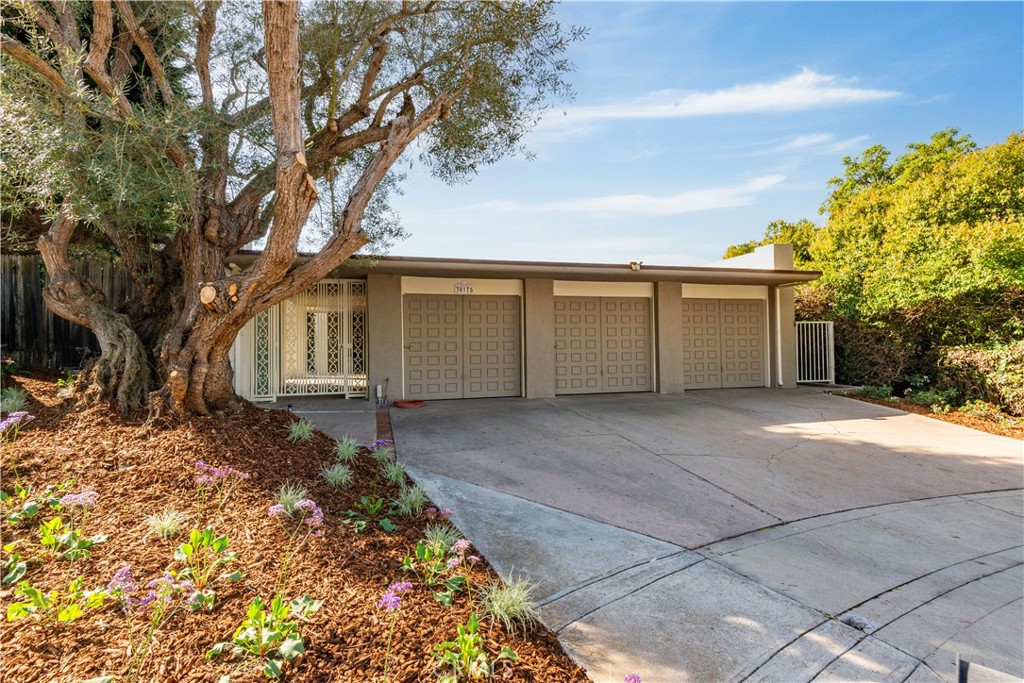 30175 Ave Tranquila Rancho Palos Verdes, CA 90275 - Photo 24 of 35 a front view of a house with a yard and garage