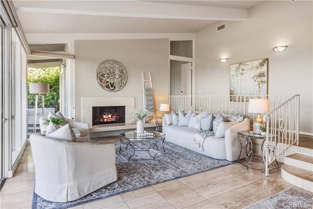 30175 Ave Tranquila Rancho Palos Verdes, CA 90275 - Photo 6 of 35 a living room with furniture a large window and a fireplace